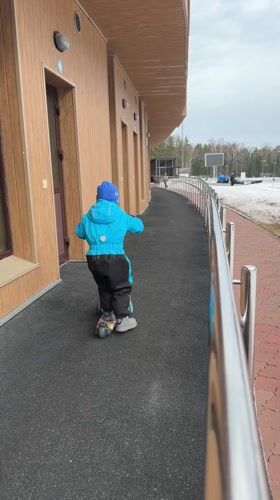 Child scooters near building amid winter scenes in Russia