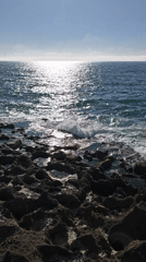 Ocean waves crash against rocky shore in Tangier