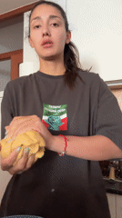 Woman in kitchen holds ball in Zankovići, Montenegro