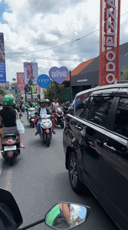 Early morning motorcycle traffic flows through North Kuta streets