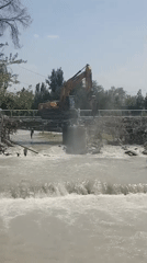 Bridge repair underway as murky river runs high in Bishkek