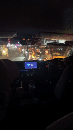 Night traffic jam with motorcycles observed in Denpasar