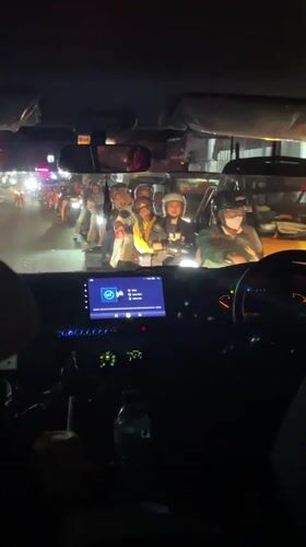 Night traffic jam with motorcycles observed in Denpasar