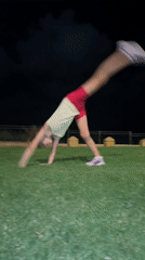 Cartwheels and tumbling on a grassy lawn in Netanya at night