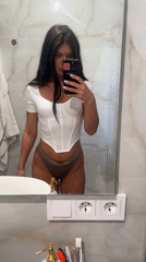 Woman takes bathroom mirror selfie in Moscow