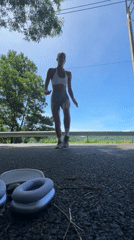 Woman performs handstands on road in Chalong, Thailand