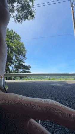 Woman performs handstands on road in Chalong, Thailand