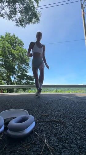 Woman performs handstands on road in Chalong, Thailand