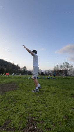Man performs gymnastics routines on field in Troyan, Bulgaria