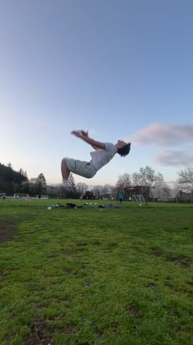 Man performs gymnastics routines on field in Troyan, Bulgaria
