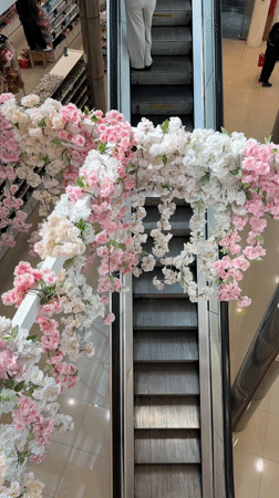 Shoppers document flower-decorated escalator at Buenos Aires mall