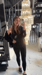 Woman takes mirror selfie in all-black outfit in Moscow