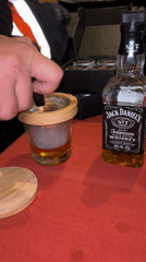 Bartender prepares smoked Jack Daniels cocktail in Den Haag