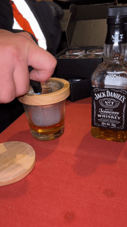 Bartender prepares smoked Jack Daniels cocktail in Den Haag