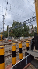 Train crosses busy Yogyakarta intersection amid morning street traffic