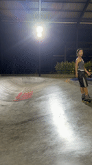 Skateboarder falls on wet concrete during rain in Dalung