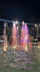 Illuminated fountain, university building captured at night in Rostov-on-Don