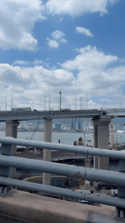 Bridge view captured showing Busan cityscape and waterway