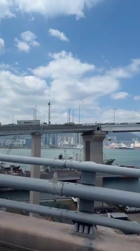Bridge view captured showing Busan cityscape and waterway