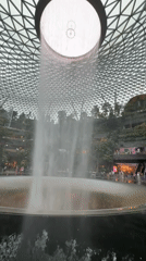 Visitors capture Rain Vortex waterfall at Singapore's Jewel Changi Airport