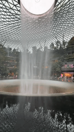 Visitors capture Rain Vortex waterfall at Singapore's Jewel Changi Airport