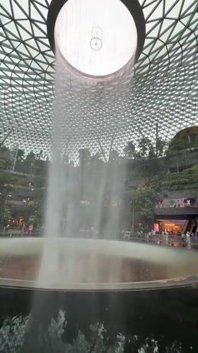 Visitors capture Rain Vortex waterfall at Singapore's Jewel Changi Airport