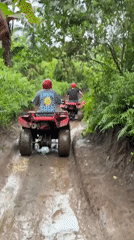 ATV riders navigate muddy jungle trails in Abiansemal