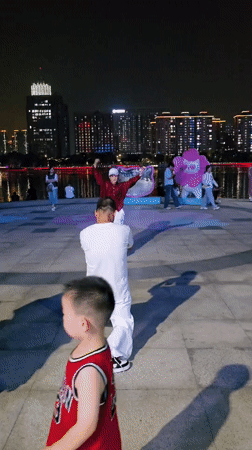 Lively summer night along the Qiantang riverfront promenade