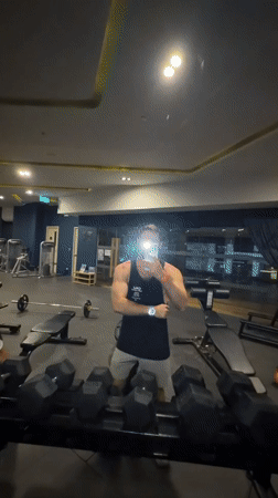 Gym selfie interrupted by surprised passerby in Thailand