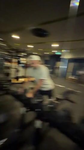 Gym selfie interrupted by surprised passerby in Thailand
