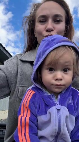 Mother and toddler's outdoor playtime documented in Kharnavy, Russia