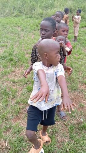 Children play traditional games in Ngalula village gathering