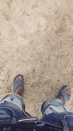 Man cooks outdoors, handles construction materials in Keffi, Nigeria