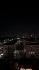 Nighttime aerial view of Kyiv buildings captured from elevated position