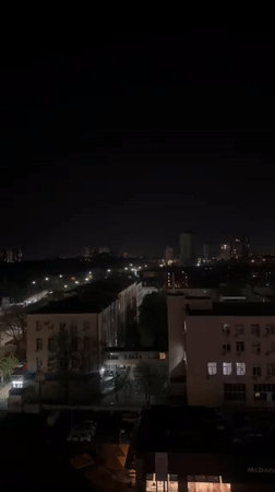 Nighttime aerial view of Kyiv buildings captured from elevated position