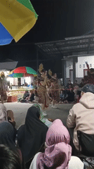 Nighttime street festival in Bono features mythological effigies and traditional performances