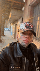 Tattooed person films self near Gothic church in Buenos Aires