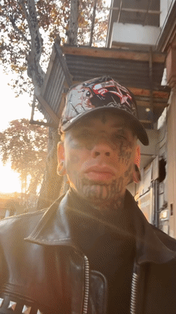 Tattooed person films self near Gothic church in Buenos Aires
