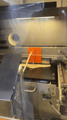 Machine dispenses white liquid onto gridded surface in Moscow