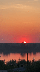 Sunset documented over water in Chaikovsky, Russia
