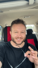 Behind the wheel in Blagoveshchensk, talking to camera with glasses in hand
