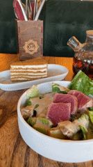 Restaurant table with seared tuna salad in Dachnoye