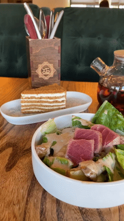 Restaurant table with seared tuna salad in Dachnoye
