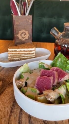 Restaurant table with seared tuna salad in Dachnoye