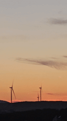 Golden hour over Seferihisar, turbines and minarets at dusk