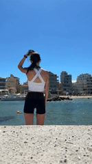 Woman takes selfies at Chania beach in Greece