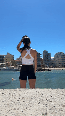 Woman takes selfies at Chania beach in Greece