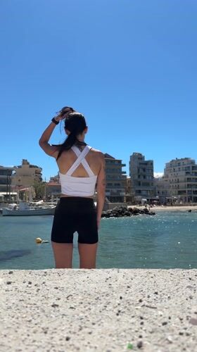 Woman takes selfies at Chania beach in Greece