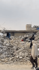 Kandahar residents clear rubble from destroyed buildings