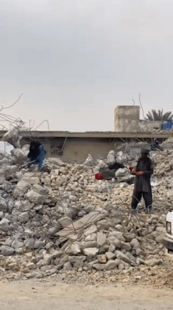 Kandahar residents clear rubble from destroyed buildings